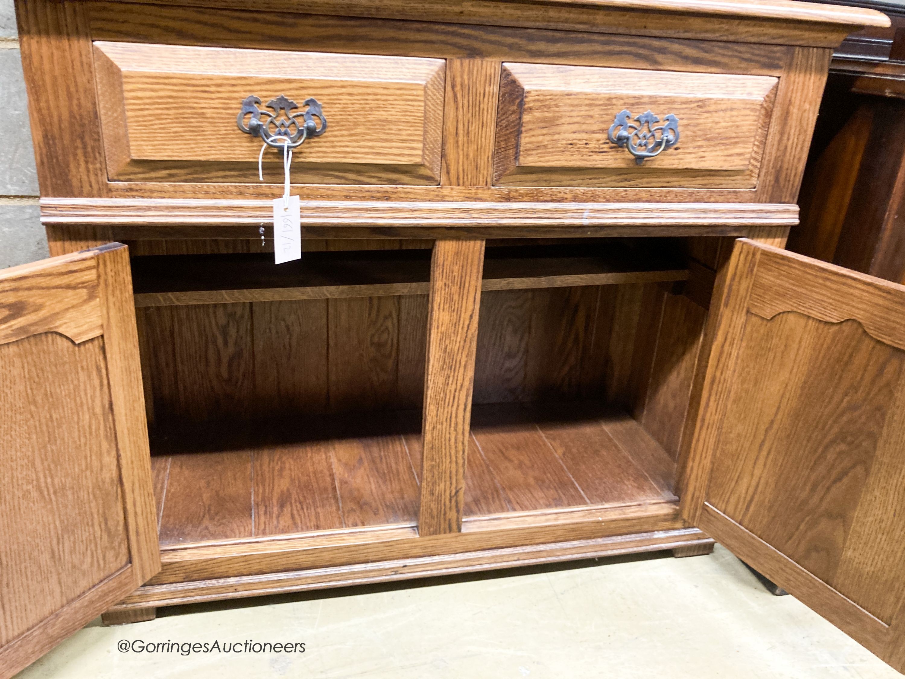 A reproduction oak bookcase cupboard, width 97cm, depth 43cm, height 190cm